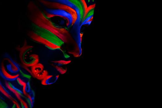 Woman with make up art of glowing UV fluorescent powder.