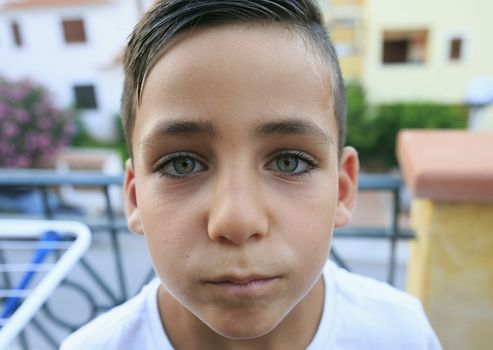 Boy with beautiful green eyes smiling