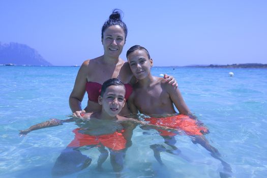 mother and her two sons on the beach