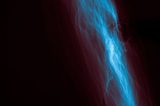 Light painted glowing abstract blue and red curved lines on a black background