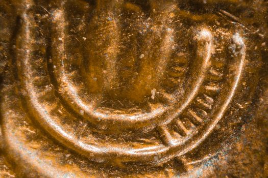 Israeli 10 Agorot coin under the microscope. Closeup macro photography.