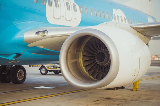 Close up view of airplane turbine engine while it being preparing ready for takeoff at ben gurion airport on sunrise.