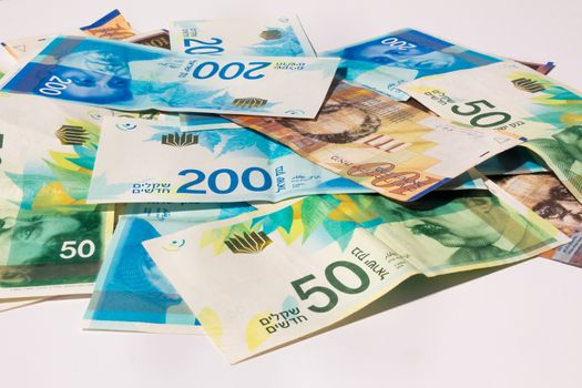 Stack of various of israeli shekel money bills.