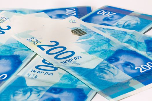 Stack of Israeli money bills of 200 shekel.