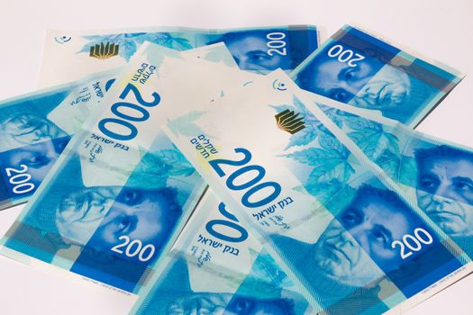 Stack of Israeli money bills of 200 shekel.