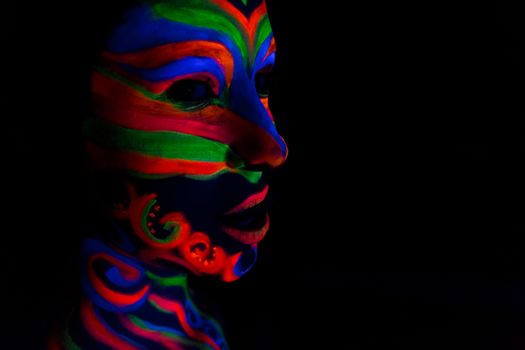 Woman with make up art of glowing UV fluorescent powder.