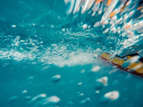 Underwater view of a moving inflatable ring that floating in the water.