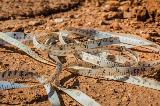 Measuring tape placed on the ground at a construction site.