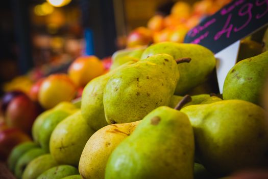 Pears and Peaches at a grocery marketplace stall.