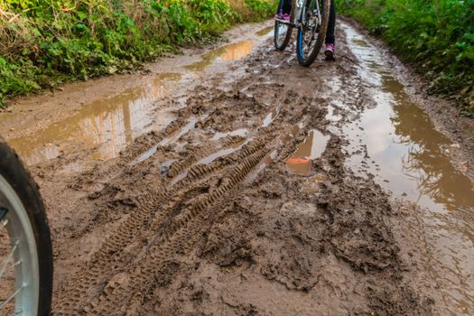 Bicycle ride through muddy dirt road.
