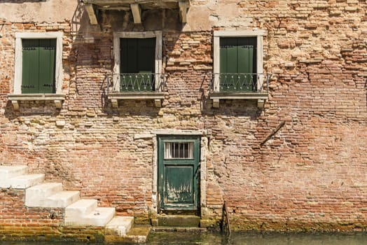 Old building along canals in Venice, Italy