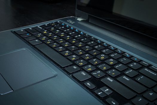 Keyboard with letters in Hebrew and English - Laptop keyboard - Dark atmosphere