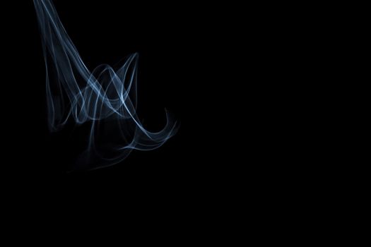 Light painted glowing abstract light blue and white curved lines on a black background