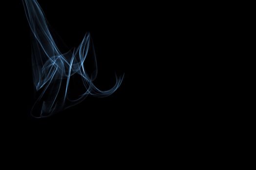 Light painted glowing abstract light blue and white curved lines on a black background