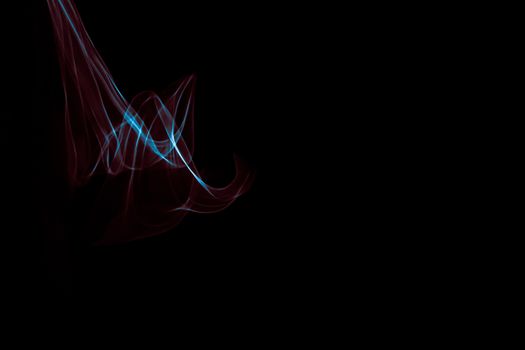 Light painted glowing abstract blue and red curved lines on a black background