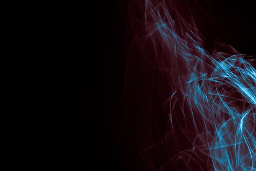 Light painted glowing abstract blue and red curved lines on a black background