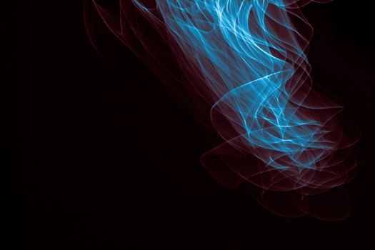 Light painted glowing abstract blue and red curved lines on a black background