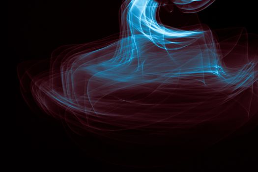 Light painted glowing abstract blue and red curved lines on a black background