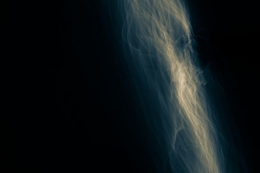 Light painted glowing abstract blue and yellow curved lines on a black background