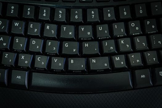 Keyboard with letters in Hebrew and English - Wireless keyboard - Top View -  Dark atmosphere