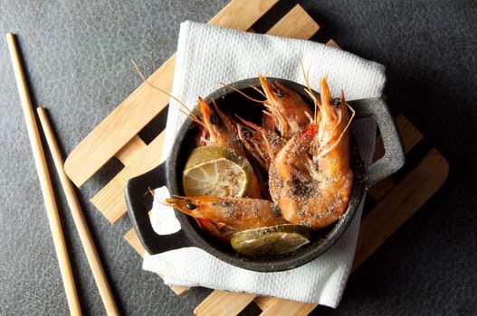 Large cooked prawns with chopsticks