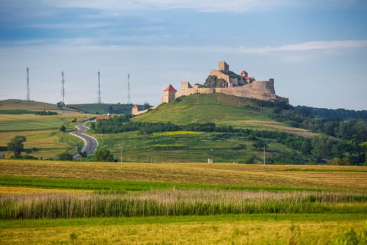 Rupea, Romania - June 23, 2013: Old medieval fortress on top of the hill, Rupea village located in Transylvania, Romania
