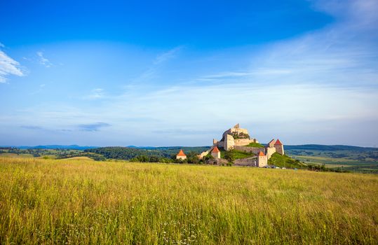 Rupea, Romania - June 23, 2013: Tourists visiting the old medieval fortress on top of the hill, Rupea village located in Transylvania, Romania