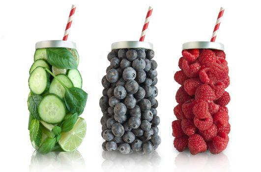 Smoothies in the shape of a beverage with straw including raspberries, blueberries and vegetables