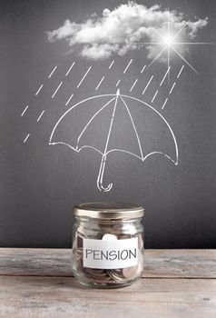 Umbrella sketch on a chalkboard protecting a jar of pension savings