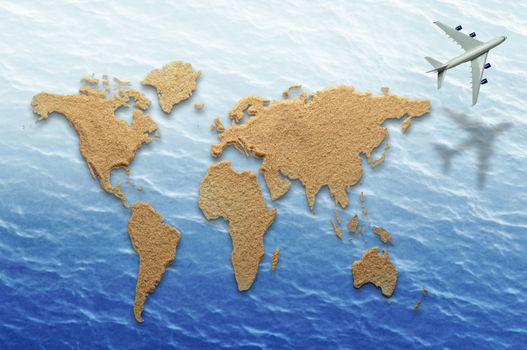 World atlas made from sand on sea background with airplane flying past 