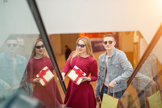 Female Shopper On Escalator In Shopping Mall