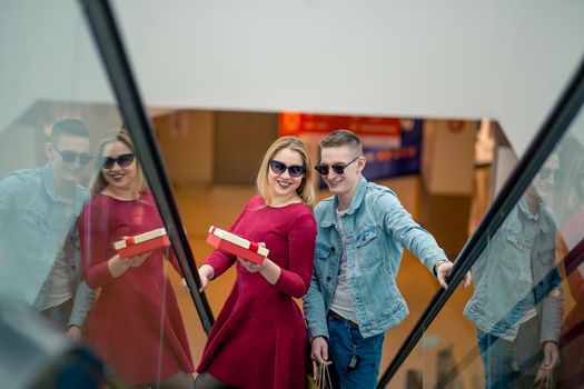 Female Shopper On Escalator In Shopping Mall