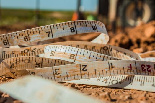 Measuring tape placed on the ground at a construction site.