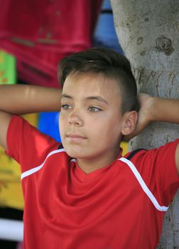 Boy with beautiful green eyes on the beach