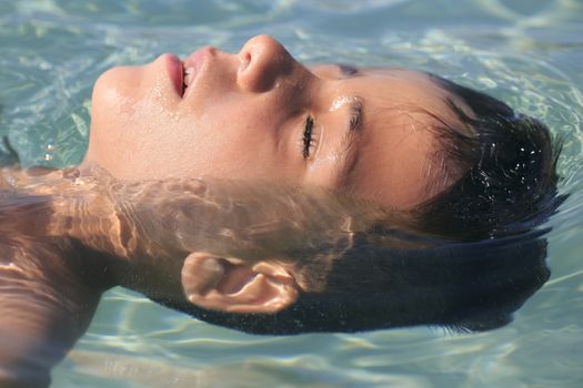 Boy swimming on the beach