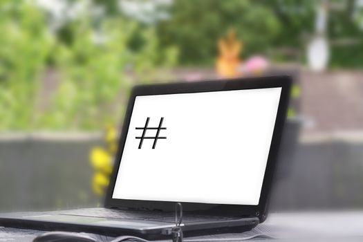 Hashtag symbol on laptop monitor. Characters for viral web network, social media.