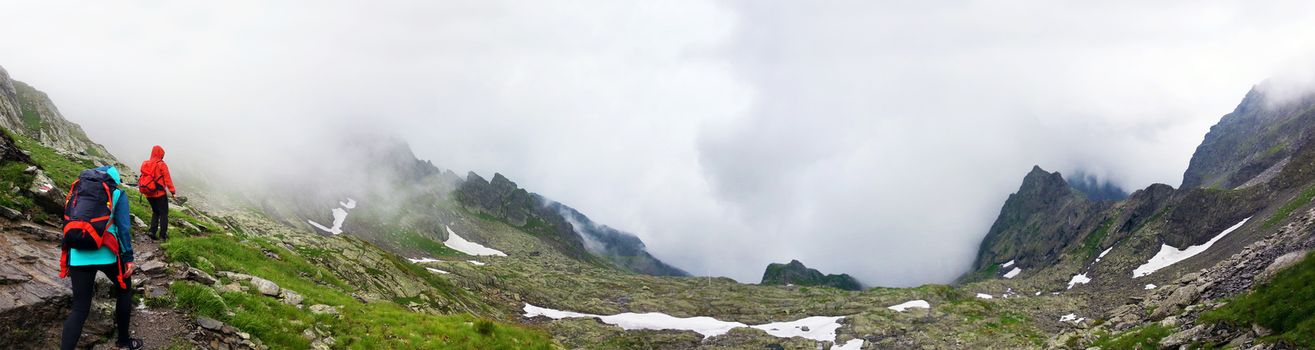 Panoramic view of FagarasHikers going to Negoiu peak on Fagaras Mountain part of the Carpathian Range, Romania