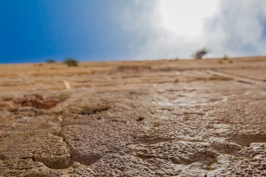 Closeup low angle view of the Western Wall in the old city of Jerusalem Israel. In the cracks between the bricks there are numerous notes with pleads and requests from people to the hebrew god.