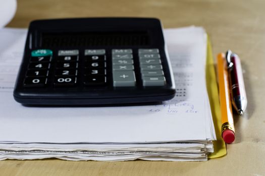 Bills, documents and papers with calculator. Office of the accounting office. Wooden table.