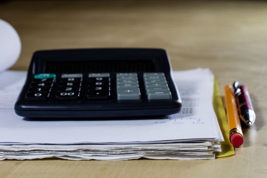 Bills, documents and papers with calculator. Office of the accounting office. Wooden table.