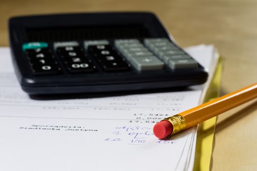 Bills, documents and papers with calculator. Office of the accounting office. Wooden table.