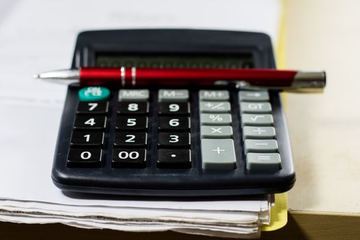 Bills, documents and papers with calculator. Office of the accounting office. Wooden table.