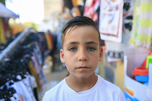 Green eyes boy smiling on the street