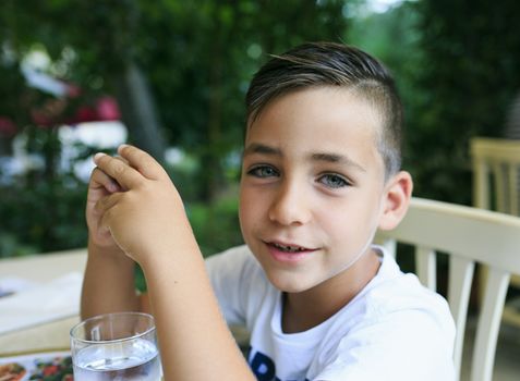 Green eyes boy smiling on the street