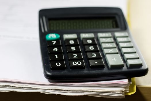 Bills, documents and papers with calculator. Office of the accounting office. Wooden table.