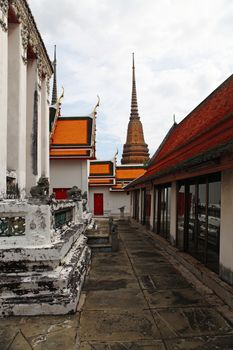 part of Beautiful Wat Phra Kaeo temple with orange and red roof in Thailand