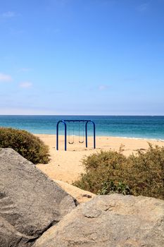 Swings on the sand at San Clemente State Beach campgrounds in Summer in Southern California