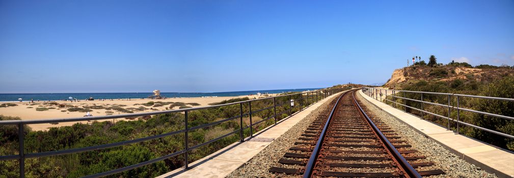 Train tracks run through San Clemente State Beach in Southern California in summer.