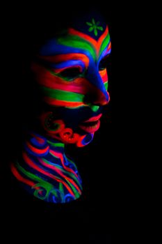 Woman with make up art of glowing UV fluorescent powder.
