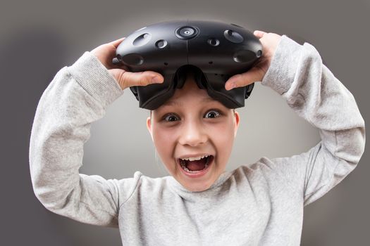 Toddler girl remove a new virtual reality headset and look camera